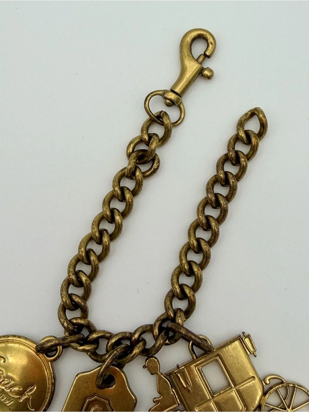 COACH Brass Charm Bracelet with Coach Tags & Horse Carriage Charm